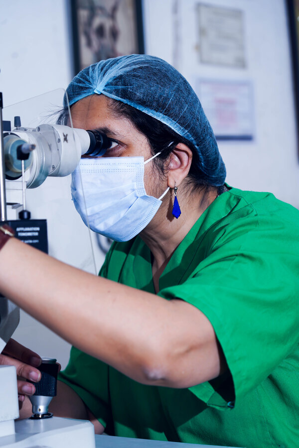 Dr. Anjali Mehta at the slit lamp